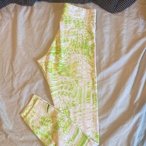 Green, white, and yellow Nike stretch pants.